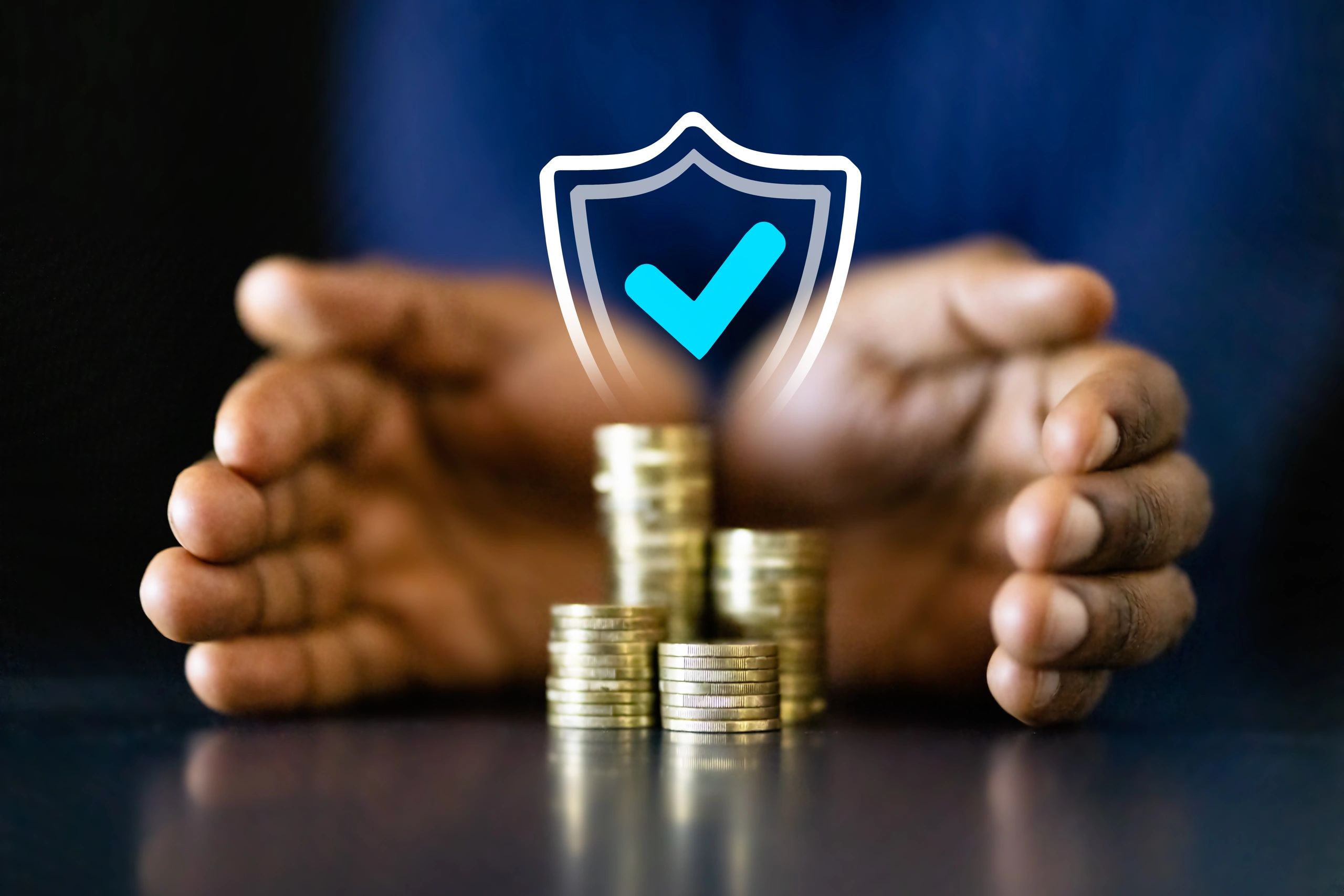 Hands holding coins with holographic shield protection